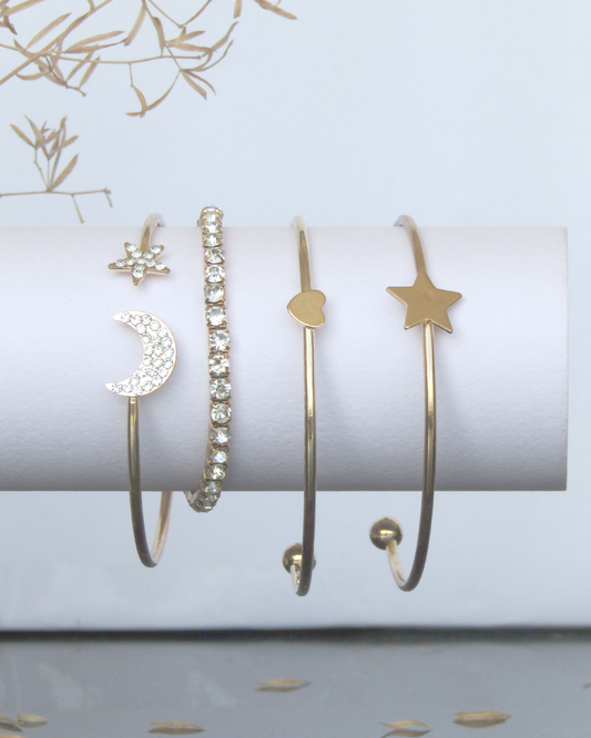 Clooz Set of gold Plated bracelets on a white surface with decorative elements.